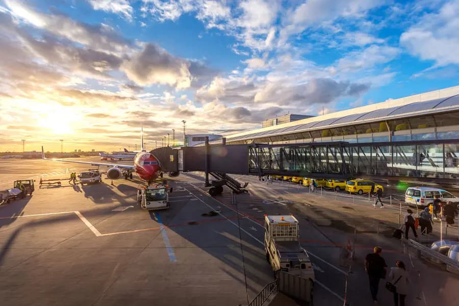 Commercial airport terminal operating at sunset